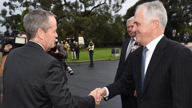 Prime Minister Malcolm Turnbull greets Leader of the Opposition Bill Shorten at a wreath laying ceremony at the Shrine of Rememberance in Melbourne on Sunday. PIC: AAP