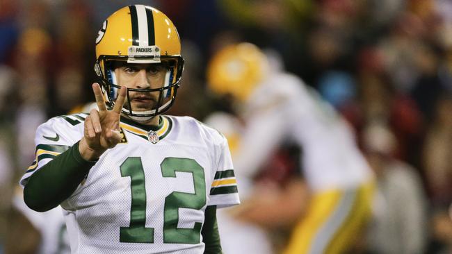 Green Bay Packers quarterback Aaron Rodgers (12) signals after running back James Starks (44) scores a touchdown during the second half of an NFL wild card playoff football game against the Washington Redskins in Landover, Md., Sunday, Jan. 10, 2016. (AP Photo/Mark Tenally)