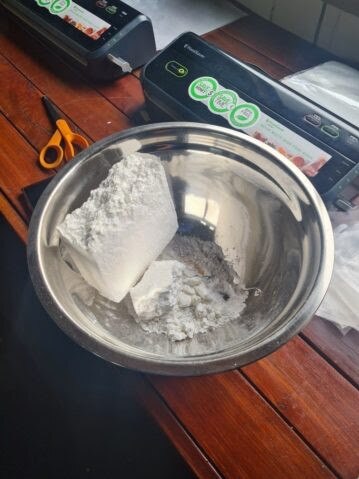 Police say they located and seized 1.6kg of cocaine, $27,000 cash, a drug press and drug related paraphernalia. Picture: QPS Media