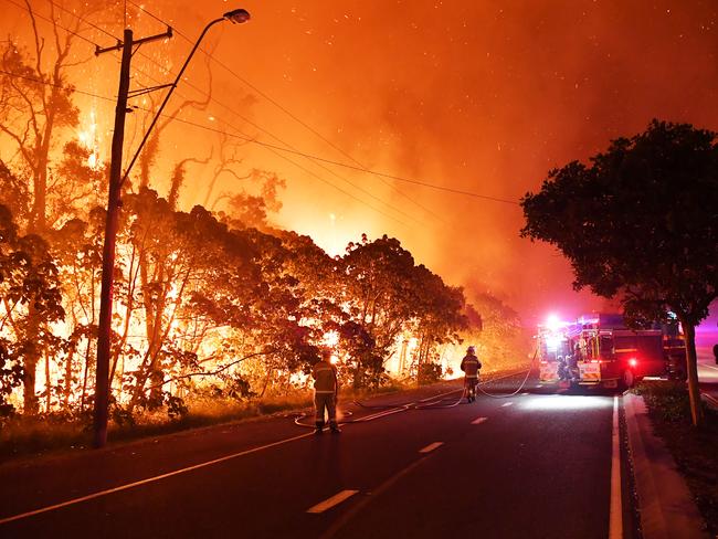 Firefighters battle a huge blaze near Peregian Beach on Queensland’s Sunshine Coast. Picture: Patrick Woods/Sunshine Coast Daily