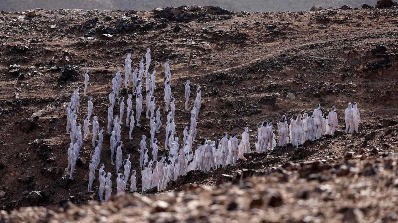 The models posed in the desert landscape. Picture: Menahem Kahana/AFP