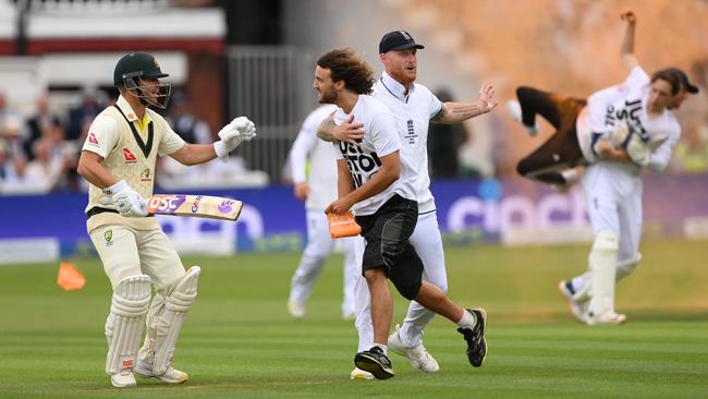 Ben Stokes and David Warner of try to stop a ‘Just Stop Oil’ protester as Jonny Bairstow carries off another. Picture: Getty Images