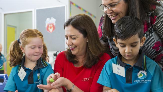 Premier Annastacia Palaszczuk and Minister for Education Grace Grace with prep students Lorelei Hansen and Schaj Dhillon at the brand new Spring Mountain State School, one of several schools which has been opened this year. Picture: Lachie Millard