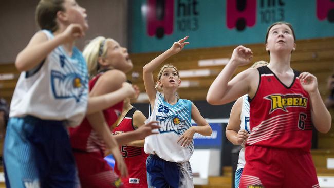 Central Coast Waves player Hayley Jackson (middle) watches her shot during the under-14 women’s basketball playoff against Gosford City Rebels at Breakers Indoor Sports Stadium. Picture: Troy Snook