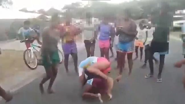 A video uploaded to YouTube shows females engaged in a violent street brawl at Yarrabah while onlookers film with their mobile phones. PICTURE: SCREENSHOT/YOUTUBE