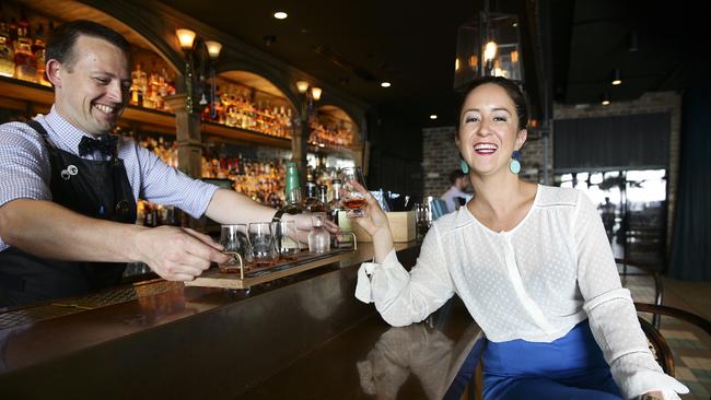 Glenn Wheeler serves Alicia Hawkins a paddle of flavoured whiskeys at Nola, Barangaroo. Picture: Justin Lloyd.