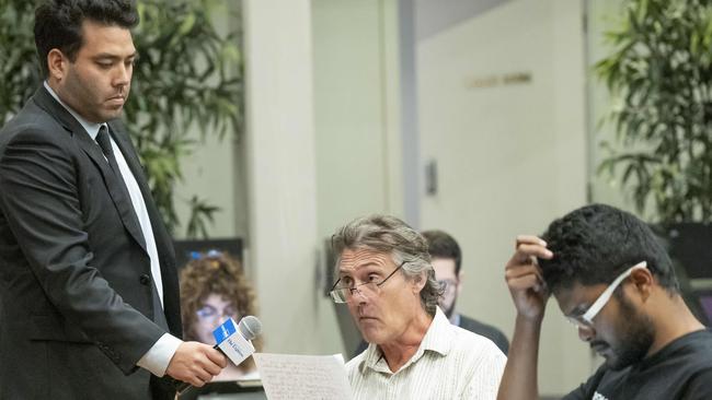 Simon Kawaguchi from NewsLocal holds the microphone for Chris Brogan of the Bankstown Bushlands Society to ask a question. Picture: Matthew Vasilescu