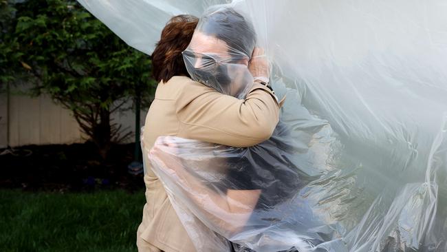 James Grant hugs his grandmother Mary Grace Sileo through a plastic drop cloth on a clothes line in Wantagh, New York. Picture: Getty Images