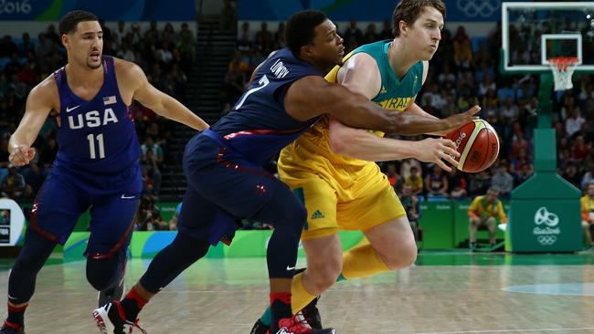 RIO DE JANEIRO, BRAZIL — AUGUST 10: Cameron Bairstow #10 of Australia moves the ball past Kyle Lowry #7 and Klay Thompson #11 of United States during a Preliminary Round Basketball game between Australia and the United States on Day 5 of the Rio 2016 Olympic Games at Carioca Arena 1 on August 10, 2016 in Rio de Janeiro, Brazil. (Photo by Elsa/Getty Images)