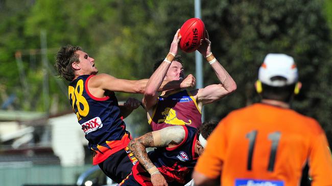 Palm Beach Currumbin player James Drake marks strongly despite efforts from Noosa Tiger Adam Eady and Jay Reynolds. Photo by Geoff Potter.