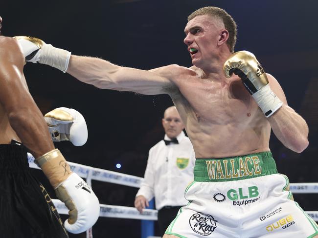 GOLD COAST, AUSTRALIA - JULY 02: Faris Chevalier (black trunks) vs Conor Wallace (green trunks) fight for the WBA Oceania Light Heavyweight Title at Gold Coast Convention and Exhibition Centre on July 02, 2022 in Gold Coast, Australia. (Photo by Peter Wallis/Getty Images)