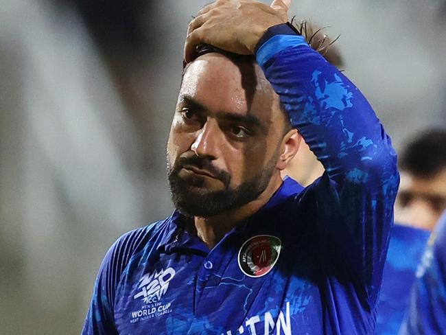 TAROUBA, TRINIDAD AND TOBAGO - JUNE 26: Rashid Khan of Afghanistan looks dejected while leaving the field after the team's defeat in the ICC Men's T20 Cricket World Cup West Indies & USA 2024 Semi-Final match between South Africa and Afghanistan at Brian Lara Cricket Academy on June 26, 2024 in Tarouba, Trinidad And Tobago. (Photo by Robert Cianflone/Getty Images)