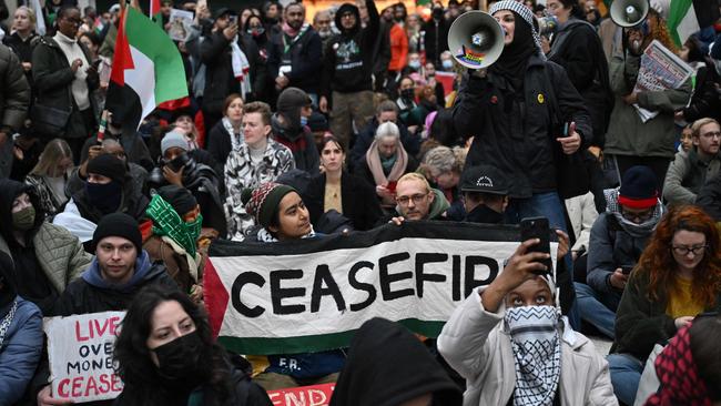 Pro-Palestinian protesters take part in a sit-down protest inside London’s Charing Cross station. Picture: AFP