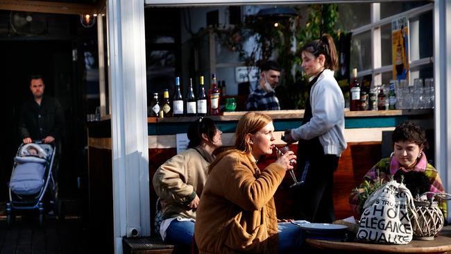 People sit outside at a cafe Germany as restrictions ease. Picture: Getty Images