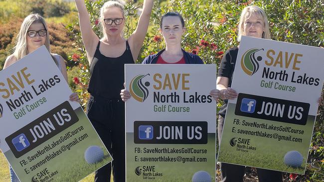 North Lakes residents Samantha Stephens, Samantha Eason, Ashlea Robinson and Jane Longmuir pose for a photograph with their demonstration signs in North Lakes. (AAP/Image Sarah Marshall)