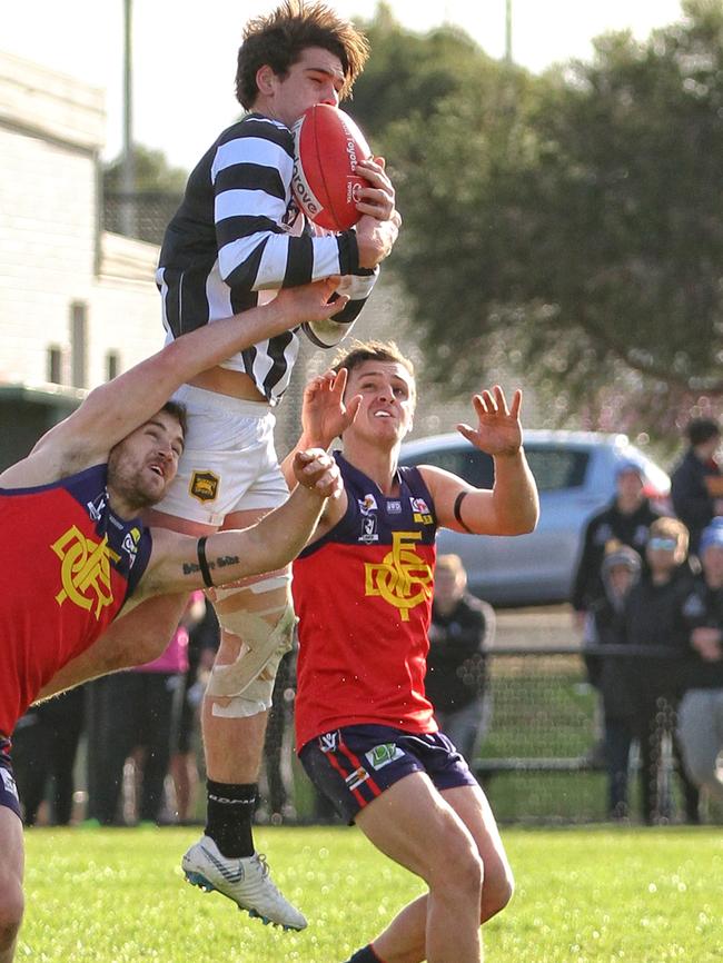 Wallan’s Nathan Fowler flies high for a big mark. Picture: Aaron Cook