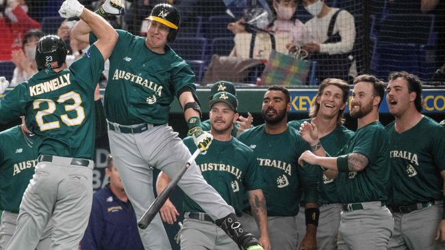 TOPSHOT - Australia's Timothy Kennelly (centre L) celebrates with teammates after hitting a home run during the World Baseball Classic (WBC) Pool B round game between Australia and South Korea at the Tokyo Dome in Tokyo on March 9, 2023. (Photo by Richard A. Brooks / AFP)