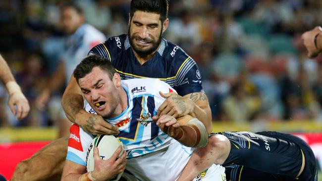 Luke Douglas tackled by James Tamou during his last season with the Titans. Picture: AAP Image/Michael Chambers.