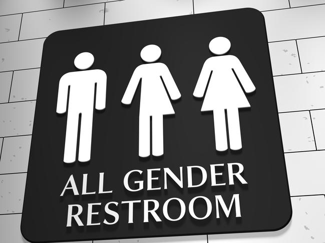 A sign on a wall for "All Gender Restroom" with symbols for men, trans and women. LGBT issue.