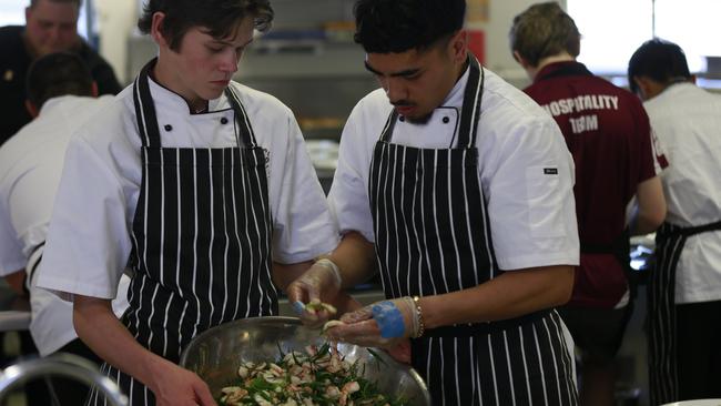 Brady Costigan and Tamarua Rawhit put the finishing touches on a fresh prawn dish.