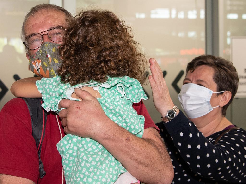 21-02-2022 Rudolf and Julianna Nemeth hug their grand daughter Lili Kaity, 5, and Brisbane International airport as borders re-open. Picture: Brad Fleet