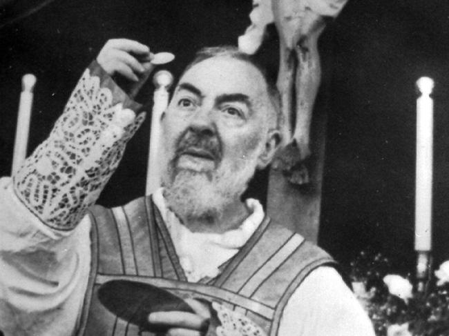 Catholic Padre Pio, a recently canonized Italian Capuchin friar famous for having "stigmata", here celebrating a Mass in Rome 29 Nov 1964. p/ NB: FEE APPLIES