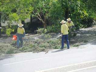 Lismore City Council workers assist with the cleanup along the Bruxner Highway near Goonellabah.