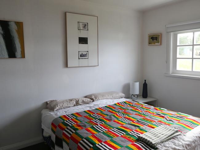 One of the two bedrooms which, like much of the home, has clean white walls. Picture: NIKKI DAVIS-JONES