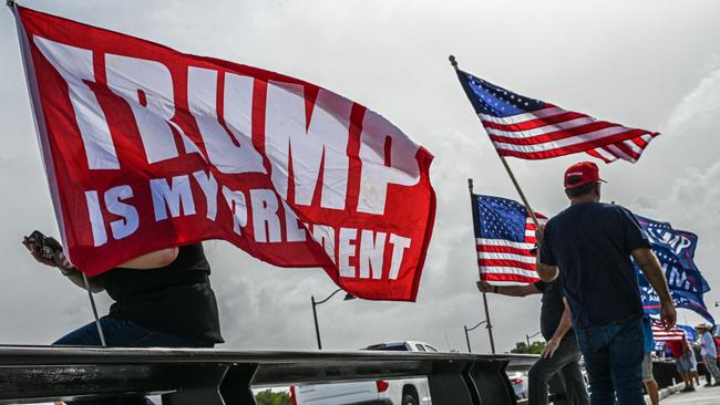 Supporters of former US president Donald Trump gather near his Palm Beach estate after the FBI raid. Picture: AFP