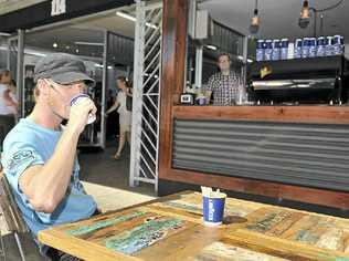 STREET SCENE: Adam Fletcher, barista at the 114 cafe on Keen St in Lismore. In the back Peter Fleming, owner of the cafe. Picture: Mireille Merlet-Shaw