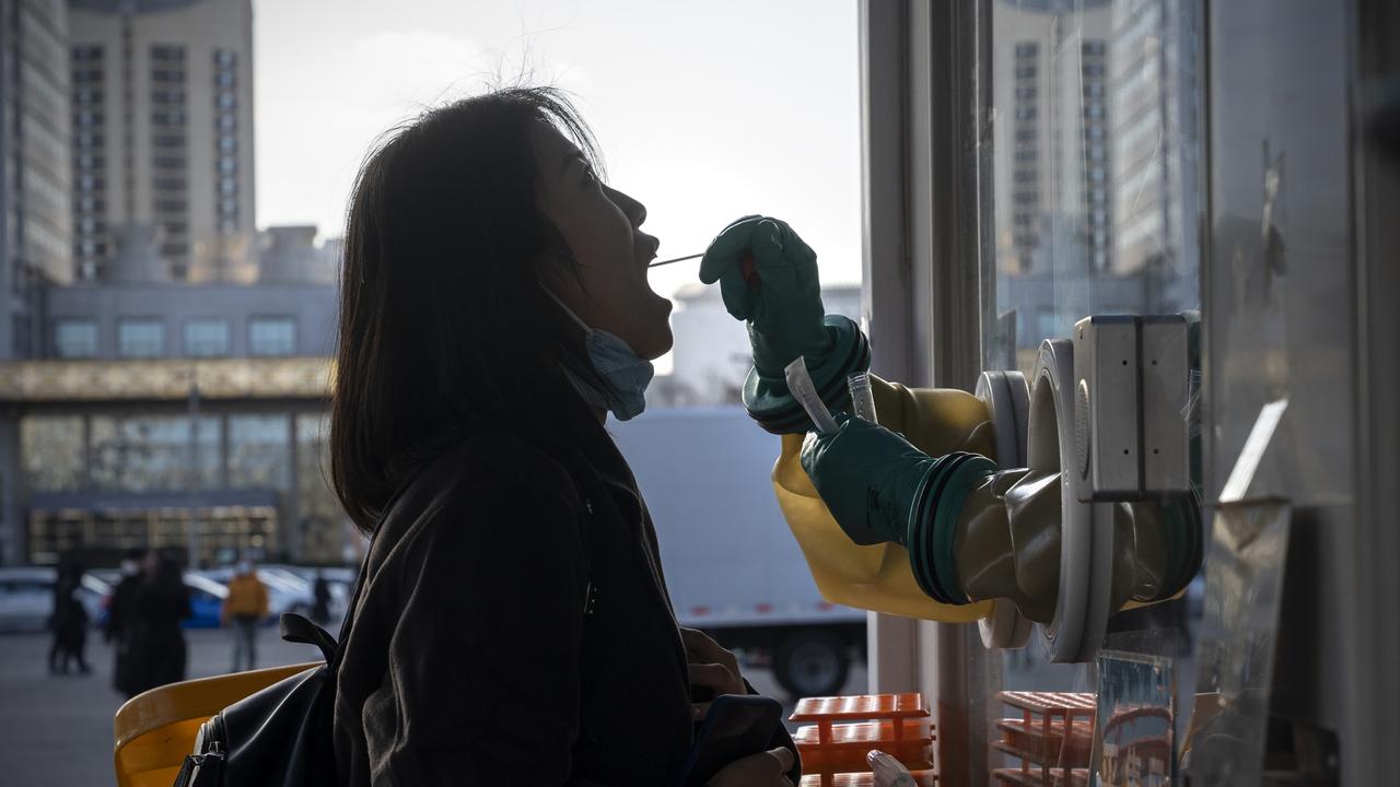 A woman gets a PCR test in Beijing, China.