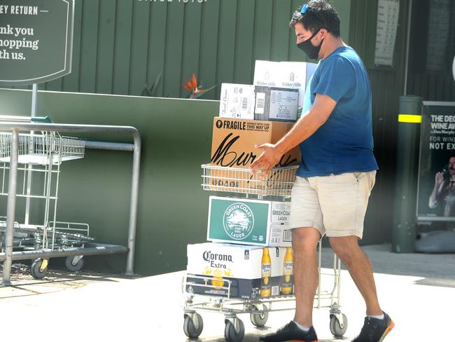 A man stocks up on alcohol at Dan Murphys Holland Park.. Picture: John Gass/NCA NewsWire