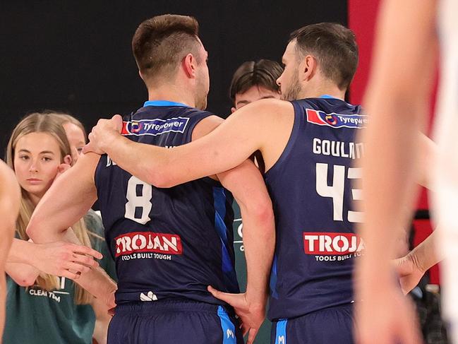 Matthew Dellavedova of United is assisted by Chris Goulding of United after a collision during the round three NBL match between Melbourne United and Brisbane Bullets at John Cain Arena. Photo: by Kelly Defina/Getty Images.