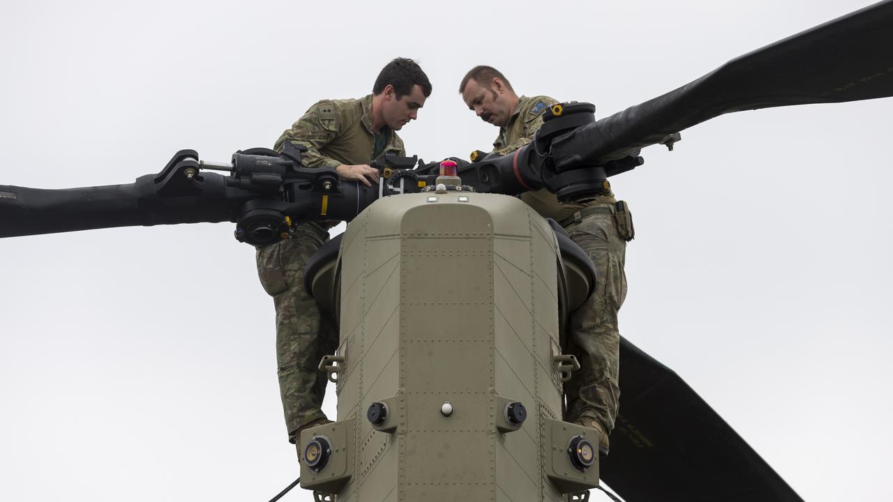 Australian Army officer Lieutenant James Fahey (left) and Corporal Corporal John Ralph inspect the rotor head of a CH-47 Chinook helicopter during Operation Bushfire Assist. *** Local Caption *** The Australian Defence Force (ADF) is continuing support to State and Territory agencies and local communities under Operation Bushfire Assist 19-20. Three Joint Task Forces have been established to facilitate ADF support to emergency services in Victoria, New South Wales and South Australia. The ADF is working alongside government and civilian agencies at all levels in support to the firefighting, relief and recovery effort by providing humanitarian, transport and other assistance such as aviation, route clearance, logistics, veterinary assistance, health services, engineering support and accommodation.