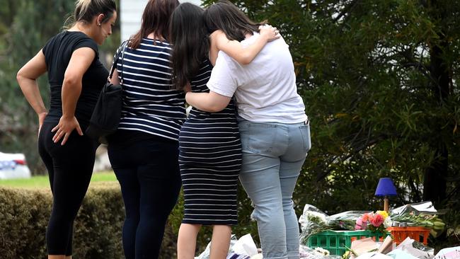 Friends console each other at Aiia Maasarwe’s tribute site. Picture: Nicole Garmston