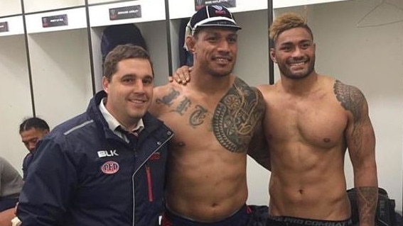 Happier times: Amanaki Mafi (right) smiles alongside teammate Lopeti Timani and coach Dave Wessels (left).