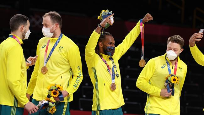 Patty Mills and his Team Australia teammates celebrate with their bronze medals during the Men's Basketball medal ceremony on day fifteen of the Tokyo 2020 Olympic Games at Saitama Super Arena on August 07, 2021 in Saitama, Japan. (Photo by Gregory Shamus/Getty Images)