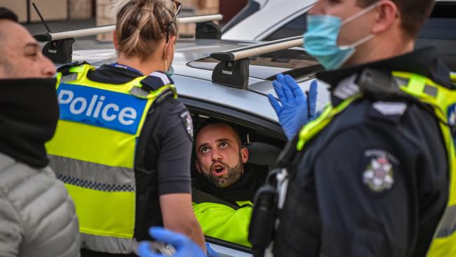 A police officer speaks with a driver on the road. Picture: Jason Edwards