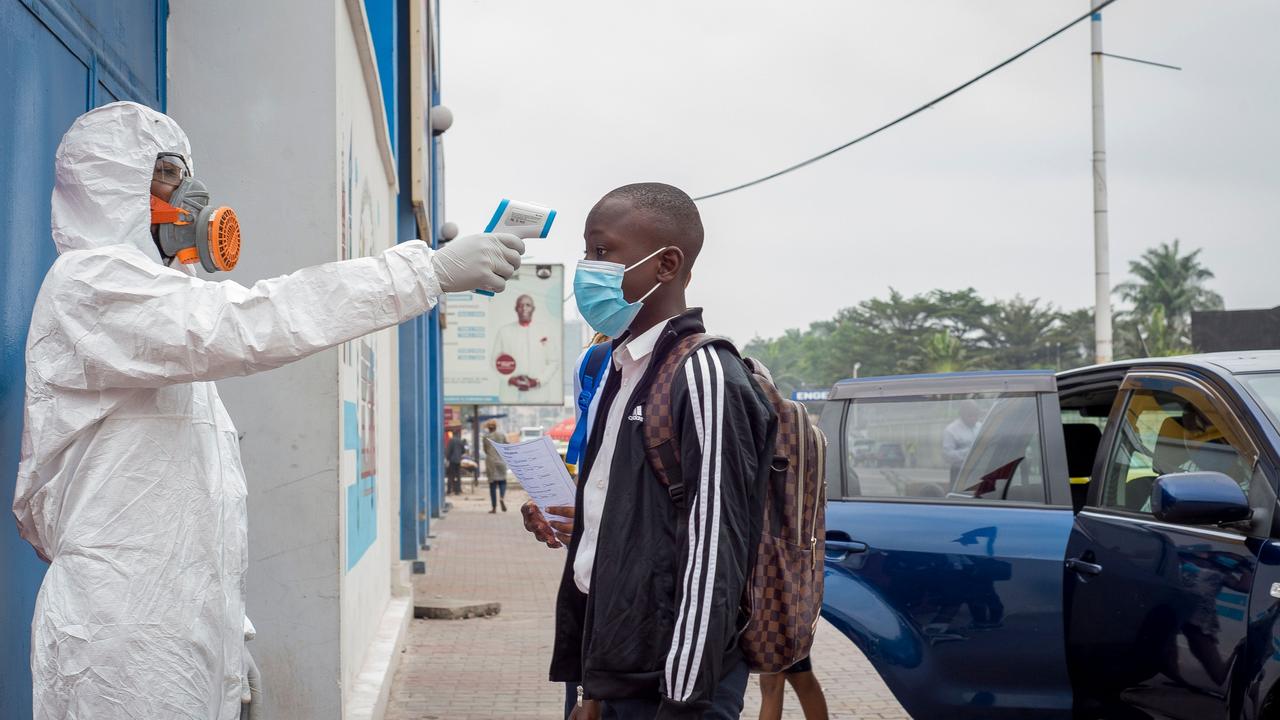 A pupil gets his temperature measured before entering a school in Kinshasa on August last week as the country began to reopen. Picture: Arsene Mpiana / AFP