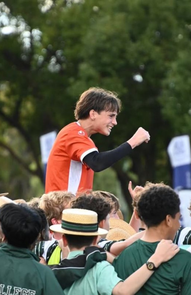 BBC goal keeper Isaac Taylor lifted up by supporters.