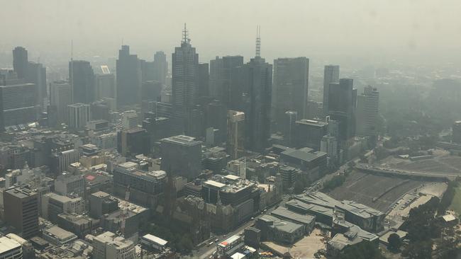 Melbourne’s CBD shrouded in haze, as seen from Eureka Skydeck. Picture: Cameron Tandy