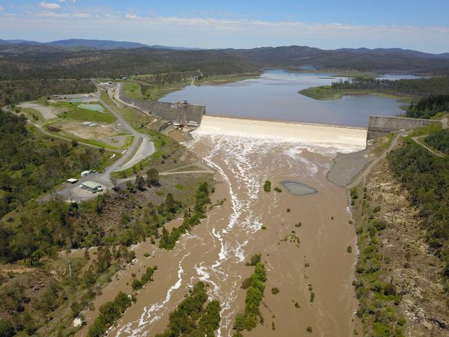 Water flows over the wall at the capacity-reduced Paradise Dam after years of drought. Picture: SunWater