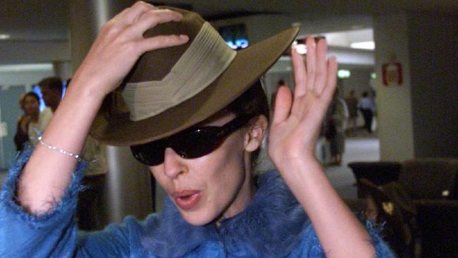 Kylie Minogue arrives home from a Christmas concert for peacekeepers in Dili, East Timor, in 1999.