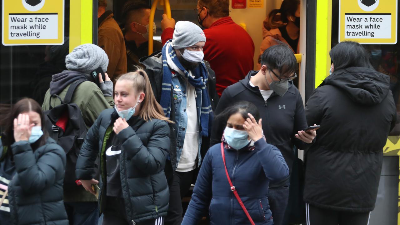 Commuters wearing masks on a Melbourne tram. Picture: NCA NewsWire / David Crosling