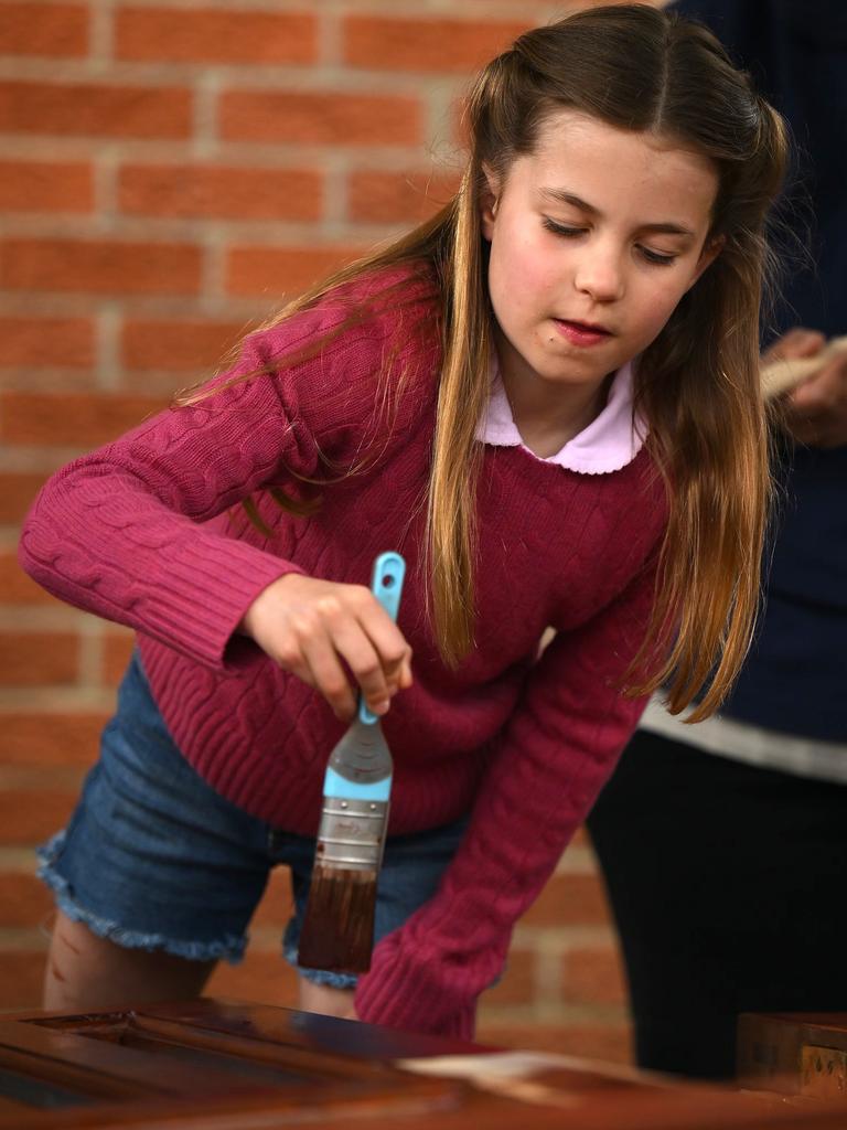 Princess Charlotte stains some wood while taking part in the Big Help Out. Picture: Getty Images