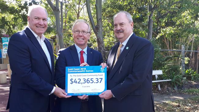 GOLDOC Chairman Peter Beattie was all smiles as he handed over a cheque to GCFF Chair Nick Scott with GOLDOC CEO Mark Peters. Photo: Brianna Morris-Grant