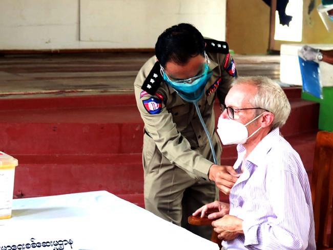 (FILES) This file handout photo from the state-run Myanmar News Agency (MNA) taken on July 28, 2021 and received on July 29 shows Sean Turnell, a detained Australian adviser to Myanmar's deposed leader Aung San Suu Kyi, getting vaccinated against the Covid-19 coronavirus in Insein prison in Yangon. - Sean Turnell, an Australian economist and former advisor to Aung San Suu Kyi detained by Myanmar's junta, has been sentenced to three years imprisonment, a source close to the case told AFP on September 29, 2022. (Photo by Handout / MYANMAR NEWS AGENCY / AFP) / RESTRICTED TO EDITORIAL USE - MANDATORY CREDIT "AFP PHOTO / MYANMAR NEWS AGENCY" - NO MARKETING - NO ADVERTISING CAMPAIGNS - DISTRIBUTED AS A SERVICE TO CLIENTS