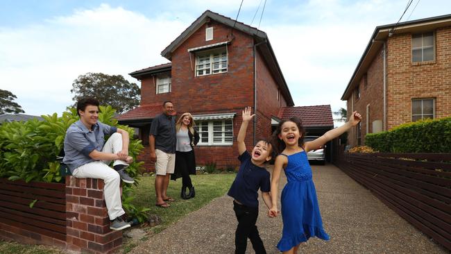 Robert and Lauren Skeen outside their sold Denistone East home, with children Kade, 13, Kingsley, 4, and Violet, 7. Picture: Hollie Adams