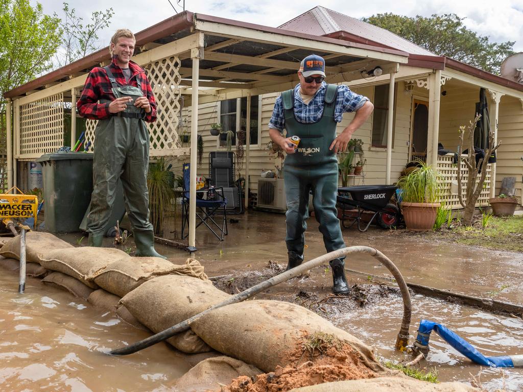 Riley Davis and Dan O’Connor outside the sandbagged general store in Tinamba. Picture: Jason Edwards