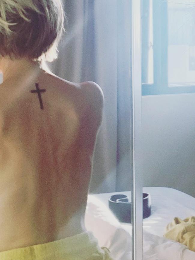 The mother-of-two has now found sobriety, and God, and has a crucifix tattooed on the nape of her neck. (Picture: Supplied)